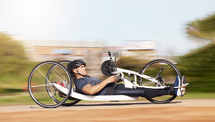 Image showing Cycling, fitness and speed with man and handcycle in nature for training, sports and challenge. Exercise, workout and motion blur with person with a disability in park for cardio and health