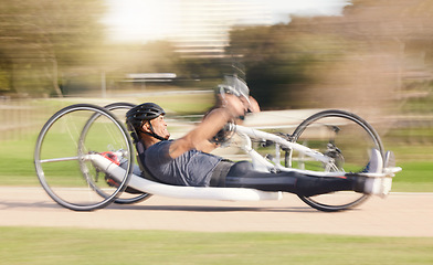 Image showing Cycling, speed and man with disability in race training for competition with action, motivation and exercise on bike. Energy, workout and person on recumbent bicycle on fast outdoor track challenge.