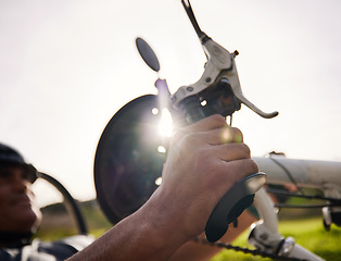 Image showing Brakes, cycling and hands on a bicycle for a person with a disability to exercise, cycle and fitness training in the park. Braking, hand on pedal or handlebars to stop, slow or control speed on bike