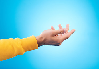 Image showing Hands, giving and man in studio for charity, donation or help with reaching gesture against blue background. Palm, asking and male person with emoji for poverty, humanity and compassion, aid or hope