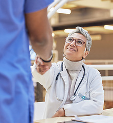 Image showing Woman, doctor and handshake with nurse for teamwork, partnership or thank you for healthcare service, meeting or hospital onboarding. Female surgeon shaking hands with nursing staff, trust or support