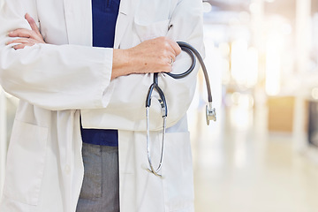 Image showing Hands, arms crossed and doctor with stethoscope for cardiology, healthcare or wellness in hospital. Medical professional, expert and heart equipment to monitor for health checkup with confidence.