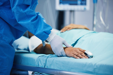 Image showing Sick, hand and a doctor with a patient in surgery for pulse, holding hands or support in bed. Hospital, medicine and closeup of a surgeon in theater with a person for consultation or medical nursing
