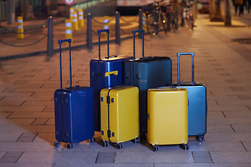 Image showing Luggage consisting of six polycarbonate suitcases standing on the street