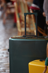 Image showing Luggage bag on the city street ready to pick by airport transfer taxi car.