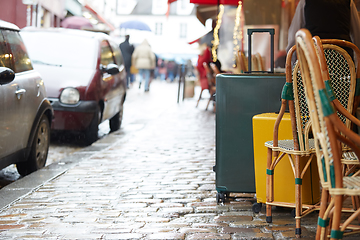 Image showing Luggage bag on the city street ready to pick by airport transfer taxi car.