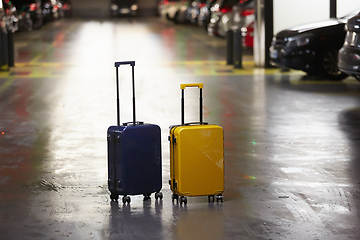 Image showing Luggage bag on the city street ready to pick by airport transfer taxi car.