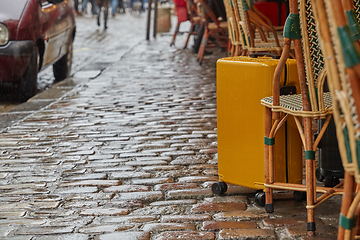 Image showing Luggage bag on the city street ready to pick by airport transfer taxi car.