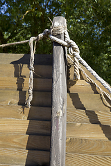 Image showing wooden building and rope