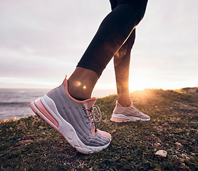 Image showing Shoes, closeup and beach ground for fitness, workout and training to start a run. Outdoor, sunset and feet with sports by the sea and ocean for exercise and running in nature with sunshine by sky