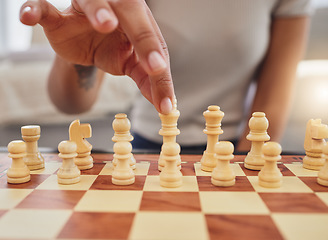 Image showing Chess, game and hand of woman with board moving piece for strategy, thinking and challenge. Competition, winning and zoom of hands of person with chessboard in living room for playing to checkmate