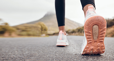 Image showing Shoes, athlete and road by a mountain outdoor ready to start a run for health and wellness. Feet, person and running fitness for workout, training and exercise with sport and active on ground ashalt