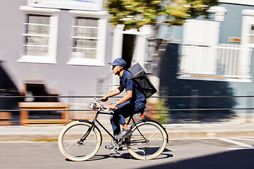 Image showing Transportation, delivery on bicycle with parcel and city street for distribution service. Eco friendly transport or logistics, cycling courier and male person with package for shipping in road