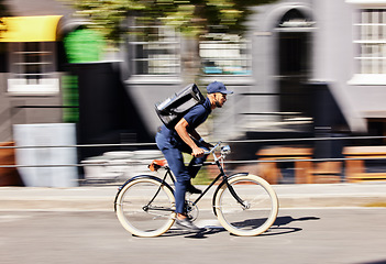 Image showing Delivery man, bicycle and motion blur in city for fast logistics, quick distribution service and order. Courier, guy or travel with speed on bike, cycle and transportation for package in urban street