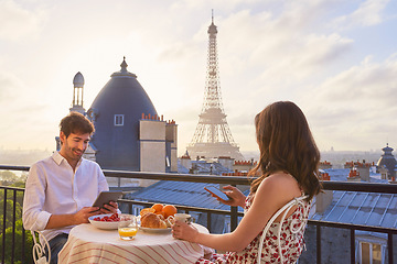 Image showing Travel, breakfast and couple in Paris with the Eiffel Tower on a terrace for romance or anniversary. City, vacation or tourism tech app with a man and woman eating food while looking at a view