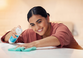 Image showing Cleaning, table and smile with woman and spray dust for disinfection, hygiene and sanitary. Cleaner, maintenance and furniture with female person and bottle at home for maid, detergent and washing
