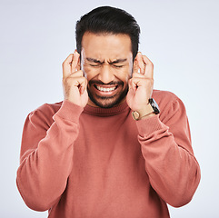 Image showing Fingers crossed, hope and man with anxiety for luck, waiting for announcement and bonus on studio white background. Nervous asian male person wish for belief, emoji and trust of winning lottery prize