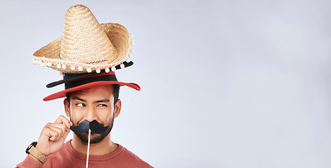 Image showing Photo booth mockup, hat and face of man in studio with mustache for comic, humor and funny joke. Happy, Mexican party accessory and excited male person on gray background with sombrero for comedy