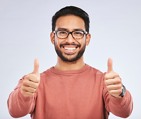 Image showing Thumbs up, portrait and man with glasses for success in studio, white background and winning news. Happy asian male model, ok emoji and like of feedback, review and vote yes in agreement of promotion