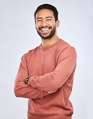 Image showing Portrait, happy or Asian man laughing with arms crossed or smile in studio in casual fashion or clothes. Relax, confidence or handsome male person smiling on white background with pride, humor or joy