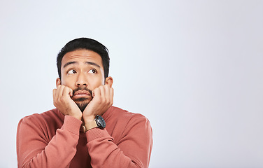 Image showing Depression, thinking and sad asian man in studio for stress or broken heart, lonely or bored on grey background. Doubt, fear and face of male with anxiety, grief or trauma and mental health crisis