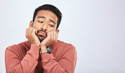 Image showing Thinking, depression and sad asian man in studio for stress or broken heart, lonely or bored on grey background. Doubt, fear and face of male with anxiety, grief or trauma and mental health crisis