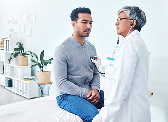 Image showing Man, doctor and cardiology with stethoscope and senior professional at a hospital for health. Listening, consultation and patient at a heart clinic for expert advice and beat hearing for healthcare