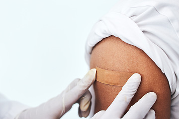 Image showing Healthcare, arm and closeup with plaster for vaccine, hands of doctor for protection and virus safety in clinic. Consultation, patient and medical professional in hospital for vaccination medicine.