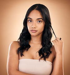 Image showing Portrait, serious woman and hair care, beauty and curly isolated in studio on a brown background. Face, natural cosmetics and female model with salon treatment for aesthetic, wellness and hairstyle.