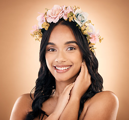 Image showing Portrait, smile and flower crown with a model woman in studio on a brown background for shampoo treatment. Beauty, salon and hair with a happy young person looking confident about natural cosmetics