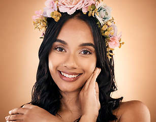 Image showing Portrait, skincare and flower crown with a model woman in studio on a brown background for shampoo treatment. Face, smile or beauty with a happy young person looking confident about natural cosmetics