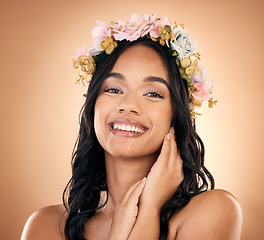 Image showing Portrait, beauty and flower crown with a model woman in studio on a brown background for shampoo treatment. Smile, salon and hair with a happy young person looking confident about natural cosmetics