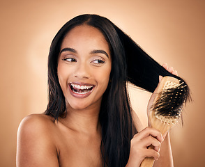 Image showing Hair care, brush and excited woman with beauty in studio isolated on a brown background. Salon, happy and model with wood grooming product for natural aesthetic, hairdresser or hairstyle for wellness