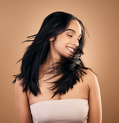 Image showing Beauty, hair and smile with woman in studio for skincare, salon treatment and keratin. Shampoo, wellness and self care with face of female model on brown background for cosmetics, collagen and glow