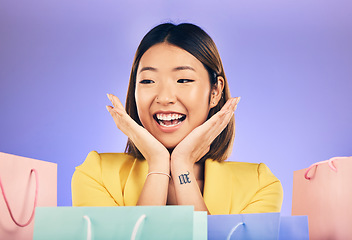 Image showing Happy, face and woman with shopping bag from a sale, promotion or customer with deal on retail clothing. Surprise, face and Asian model with smile emoji or crazy discount on luxury product or store