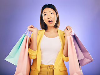 Image showing Surprise, wow and portrait of woman with shopping bag from a sale, promotion or customer with deal on retail clothing. Face, Asian model with shock, emoji or crazy discount on luxury product or store