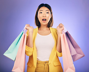 Image showing Wow, surprise and portrait of woman with shopping bag from a sale, promotion or customer with deal on retail clothing. Face, Asian model with shock, emoji or crazy discount on luxury product or store