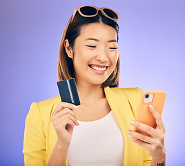 Image showing Woman, phone and credit card of e commerce, online shopping or fintech payment on studio purple background. Fashion sale and happy asian person on internet banking, subscription or mobile transaction