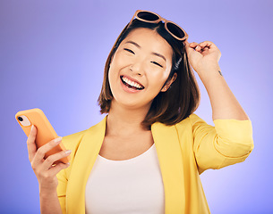 Image showing Happy asian woman, portrait and phone in fashion for communication against a purple studio background. Female person or model with smile for networking or stylish clothing on mobile smartphone app