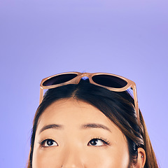 Image showing Thinking, face and woman with sunglasses for summer, vacation or idea for holiday on purple studio background. Choice, decision and Asian model with glasses on head for beach, style or fashion