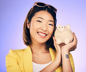 Image showing Piggy bank, finance portrait and woman with savings, investment and happy for budget insurance. Young asian person for financial management, money safe or banking security on studio purple background