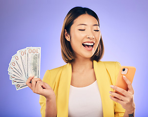 Image showing Cash, phone and happy woman for winning finance, online savings or fintech profit and cashback. Success, lottery and winner or asian person on mobile, money fan or banking on studio purple background