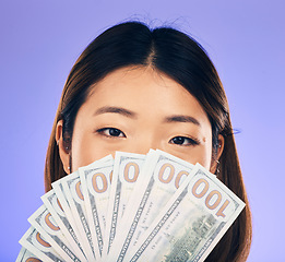 Image showing Money, winner and woman cover face on purple, studio background for winning, cash fan or financial loan. Lottery, bank and asian person or winner bonus, budget secret and finance profit in portrait