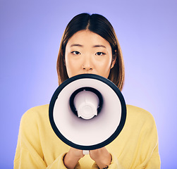 Image showing Woman, megaphone and portrait in studio for announcement, voice or broadcast. Face of a young asian female speaker with a loudspeaker for communication, sad message or speech on purple background