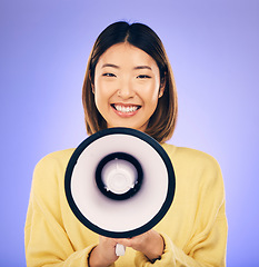 Image showing Woman, megaphone and happy portrait in studio for announcement, voice or broadcast. Face of a young asian female speaker with a loudspeaker for communication, message or speech on purple background