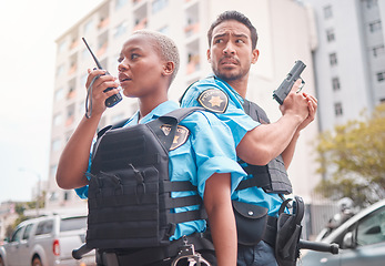 Image showing Team, gun and police in the city for crime, talking into equipment and ready for action. Security, law and a black woman and man speaking into gear while in collaboration for criminal activity