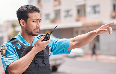 Image showing Asian man, police and pointing with walkie talkie in city for emergency dispatch, arrest or calling suspect. Male person, cop or law enforcement with radio signal for communication or safety in town