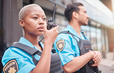 Image showing Police, radio and patrol with a black woman officer outdoor on a city street for law enforcement. Walkie talkie, communication and a female security guard talking during crime prevention for safety