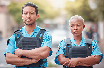 Image showing People, police and arms crossed in city for law enforcement, safety and protection outdoors. Portrait of man and woman cop or security guard in teamwork to protect and serve the community in town