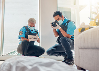 Image showing People, police and investigation at the crime scene for murder, victim or case of death at home. CSI man and woman writing notes, pictures or photography for law enforcement or evidence in the house